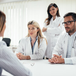 Team of doctors talking to a patient in the office | Caring for Patients During the Coronavirus Pandemic | RSC SF Bay Area