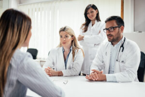 Team of doctors talking to a patient in the office about care during the coronavirus pandemic | RSC SF Bay Area