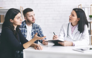 attentive couple listening to doctor to have a safe pregnancy during COVID-19 | RSC SF Bay Area