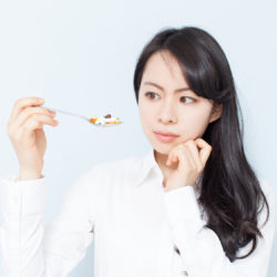 Woman Eating CoEnzyme Q-10 and DHEA Fertility Supplements | RSC SF Bay Area Fertility Clinic