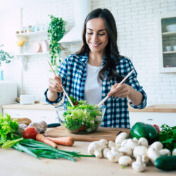 Woman preparing a healthy salad as part of a PCOS diet | Reproductive Science Center of the SF Bay Area